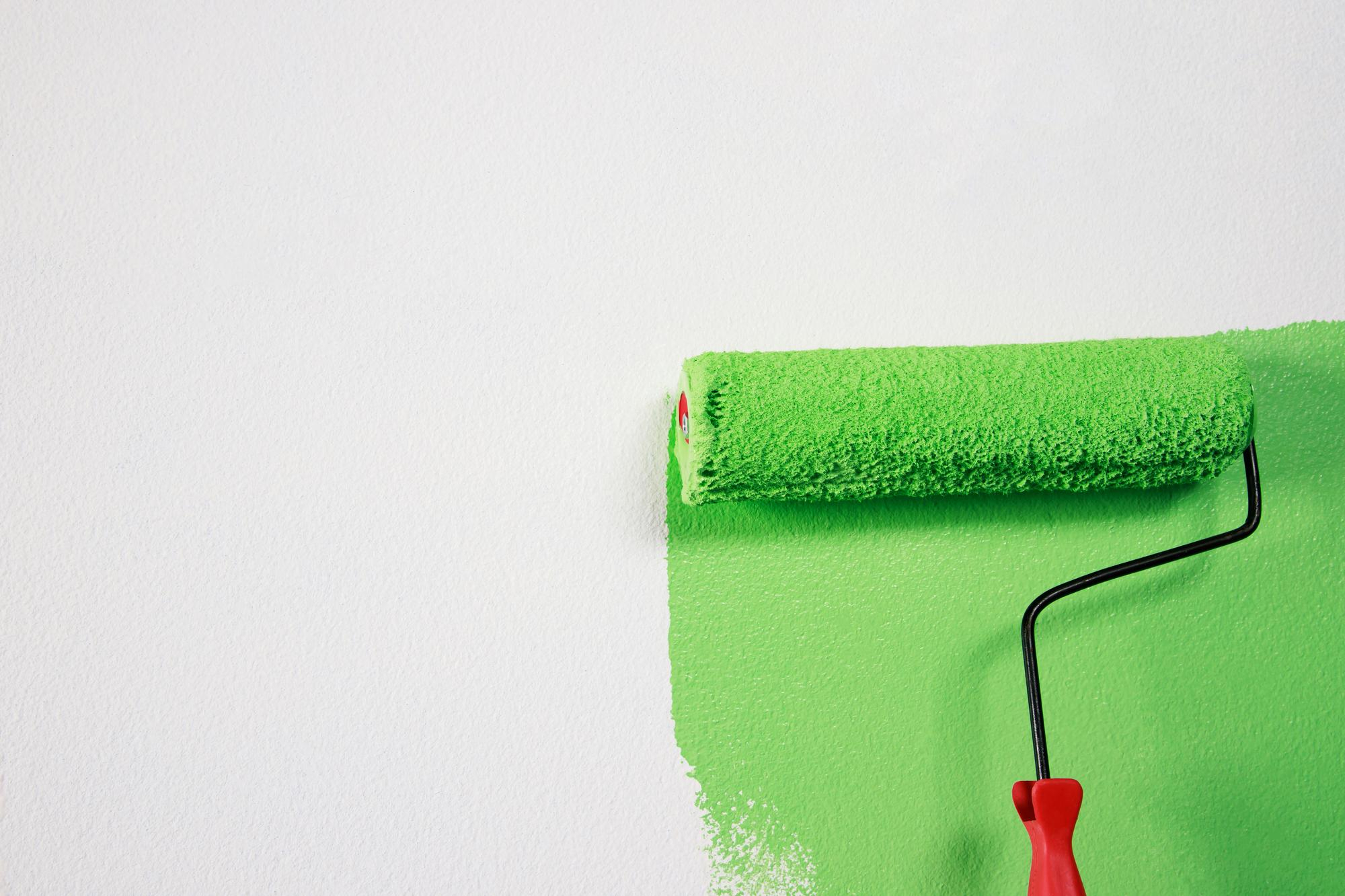 roller-brush-painting-worker-painting-surface-wall-painting-apartment-renovating-with-green-color-paint